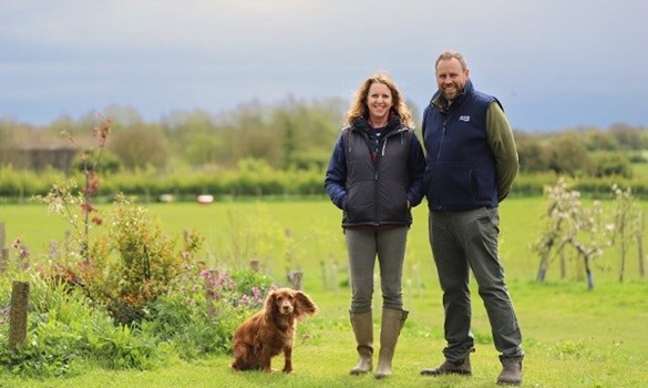 Debbie and Tom Reynolds stood in a field with their dog