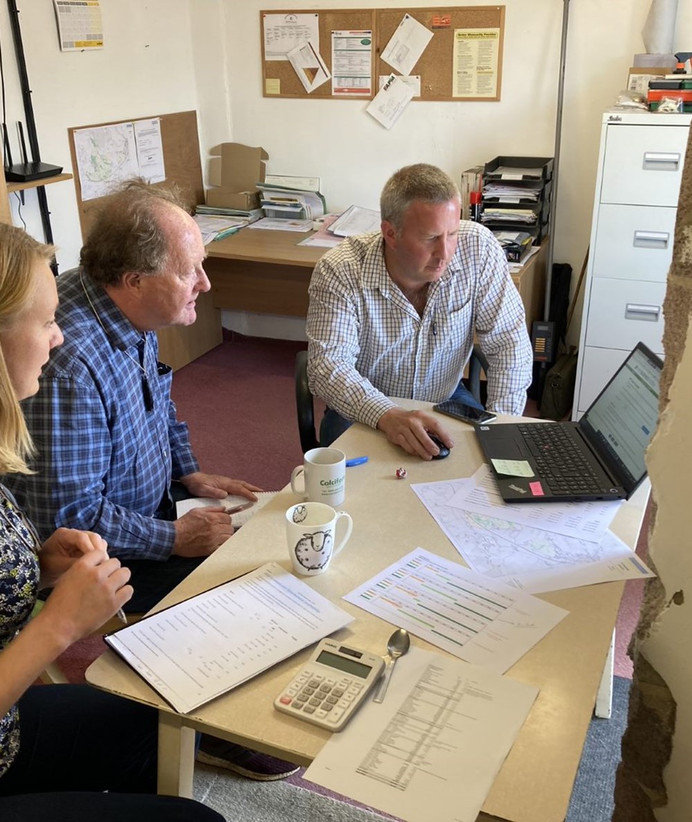 Farmer farm office consultant looking at business records