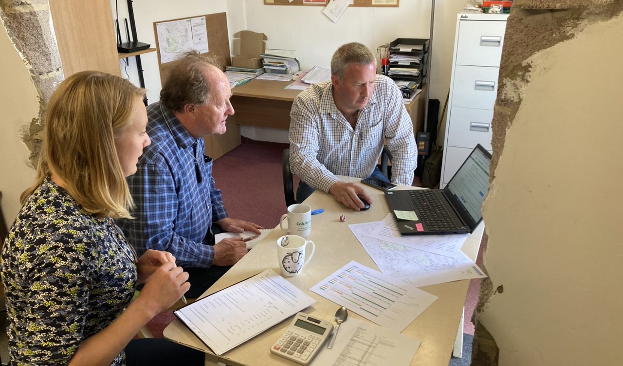 Farmer farm office consultant looking at business records