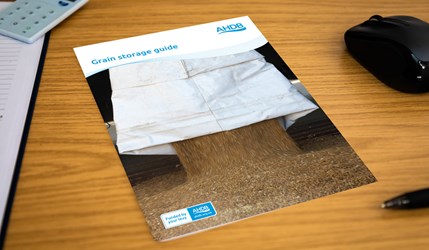 Grain storage guide on a desk.
