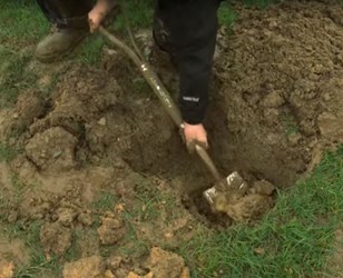 a person digging a hole in the ground